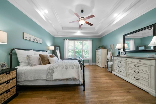 7251 Bluewater Ln, Douglasville, GA 30135 - bedroom featuring a raised ceiling, wood finished floors, ornamental molding, a ceiling fan, and baseboards
