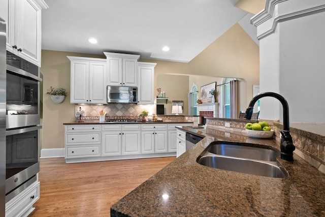 7251 Bluewater Ln, Douglasville, GA 30135 - kitchen featuring appliances with stainless steel finishes, a sink, backsplash, white cabinetry, and recessed lighting