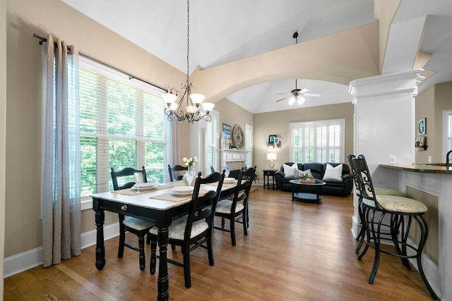 7251 Bluewater Ln, Douglasville, GA 30135 - dining area with vaulted ceiling, ceiling fan, arched walkways, and wood finished floors