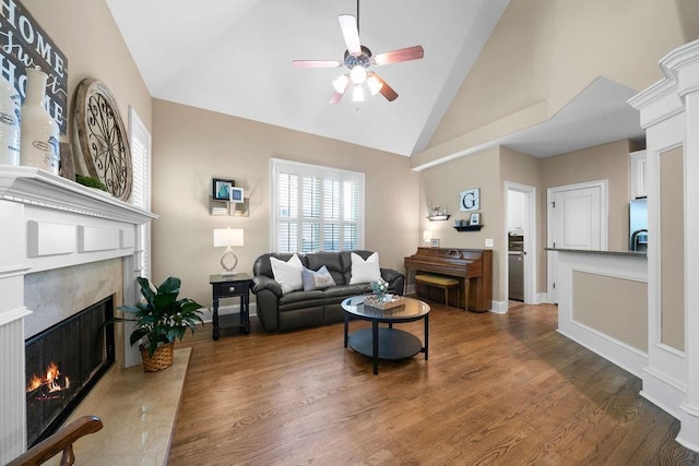 7251 Bluewater Ln, Douglasville, GA 30135 - living area with ceiling fan, a premium fireplace, high vaulted ceiling, and wood finished floors