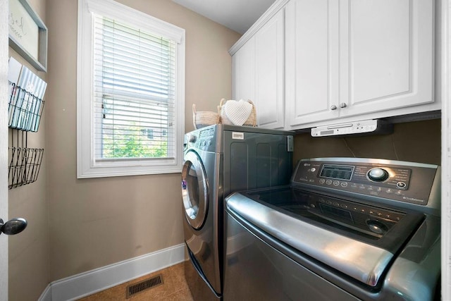 7251 Bluewater Ln, Douglasville, GA 30135 - laundry room with baseboards, cabinet space, washer and clothes dryer, and healthy amount of natural light