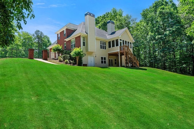 7251 Bluewater Ln, Douglasville, GA 30135 - back of house with a sunroom, stairs, and a chimney