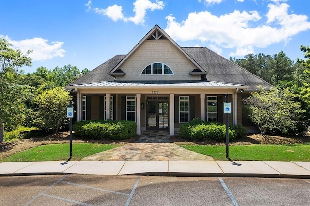 7251 Bluewater Ln, Douglasville, GA 30135 - view of front of home with a porch, a standing seam roof, uncovered parking, metal roof, and a shingled roof