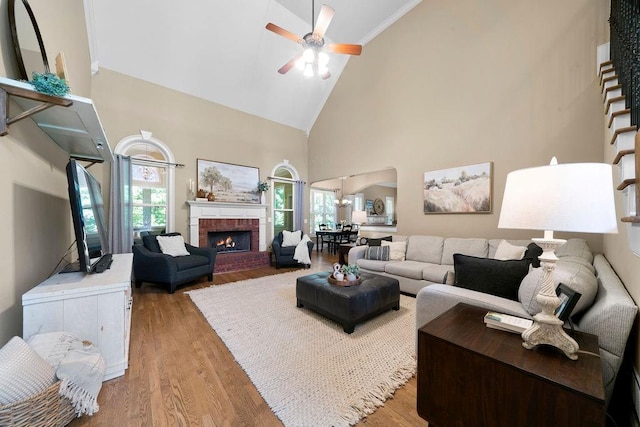 7251 Bluewater Ln, Douglasville, GA 30135 - living area with high vaulted ceiling, a ceiling fan, wood finished floors, arched walkways, and a fireplace
