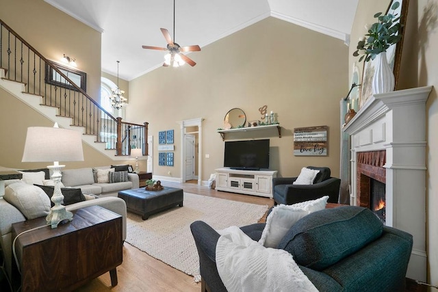 7251 Bluewater Ln, Douglasville, GA 30135 - living room with stairway, crown molding, light wood-type flooring, high vaulted ceiling, and ceiling fan