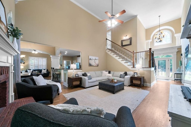 7251 Bluewater Ln, Douglasville, GA 30135 - living area featuring a ceiling fan, ornamental molding, wood finished floors, a towering ceiling, and ornate columns