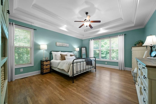 7251 Bluewater Ln, Douglasville, GA 30135 - bedroom with a raised ceiling, ornamental molding, wood finished floors, baseboards, and a ceiling fan