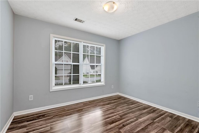 285 Kentshire Pl, Lawrenceville, GA 30044 - empty room featuring dark wood finished floors, baseboards, and a textured ceiling