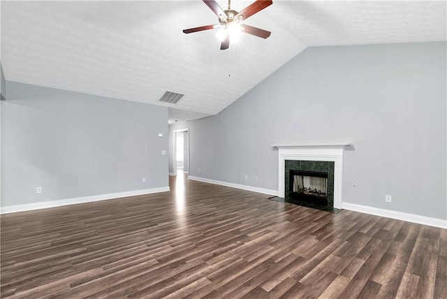 285 Kentshire Pl, Lawrenceville, GA 30044 - unfurnished living room featuring dark wood-style floors, a ceiling fan, a fireplace with flush hearth, vaulted ceiling, and baseboards
