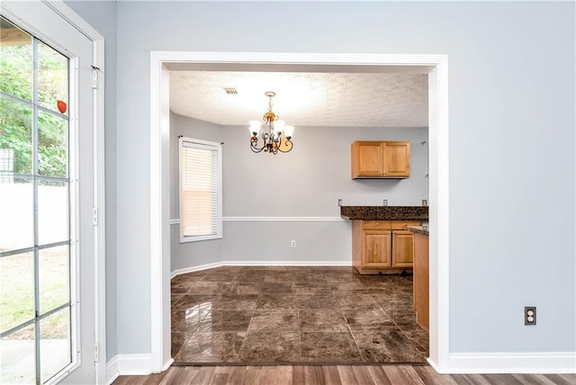 285 Kentshire Pl, Lawrenceville, GA 30044 - unfurnished dining area featuring a chandelier, plenty of natural light, and baseboards