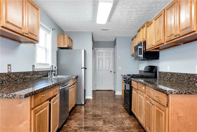 285 Kentshire Pl, Lawrenceville, GA 30044 - kitchen with stainless steel appliances, a sink, dark stone countertops, and baseboards