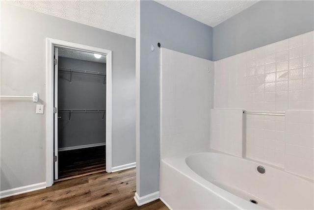 285 Kentshire Pl, Lawrenceville, GA 30044 - full bathroom with wood finished floors, baseboards, a spacious closet, and bathtub / shower combination