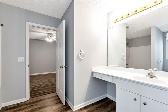 285 Kentshire Pl, Lawrenceville, GA 30044 - full bath with wood finished floors, a textured ceiling, baseboards, vanity, and a shower