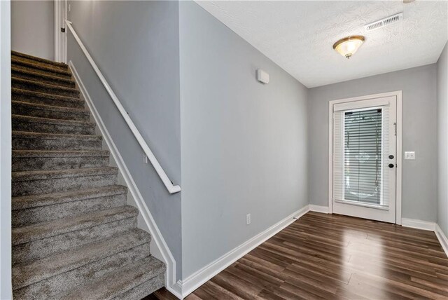 285 Kentshire Pl, Lawrenceville, GA 30044 - entrance foyer featuring stairway, dark wood-style floors, baseboards, and a textured ceiling