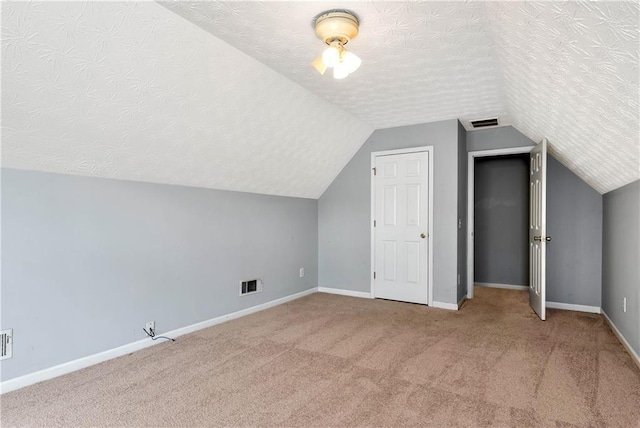 285 Kentshire Pl, Lawrenceville, GA 30044 - additional living space featuring a textured ceiling, lofted ceiling, carpet flooring, and baseboards