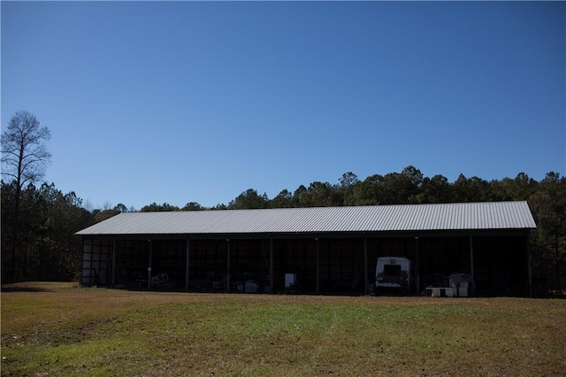 view of outbuilding featuring a yard