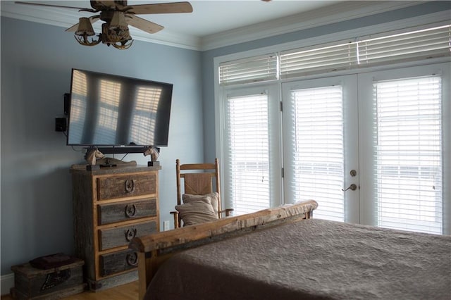 bedroom featuring multiple windows, ceiling fan, wood-type flooring, and ornamental molding