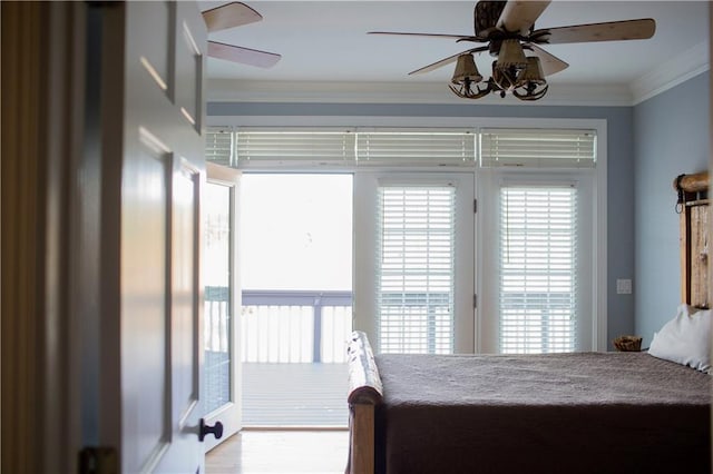 bedroom featuring ceiling fan, hardwood / wood-style flooring, and ornamental molding