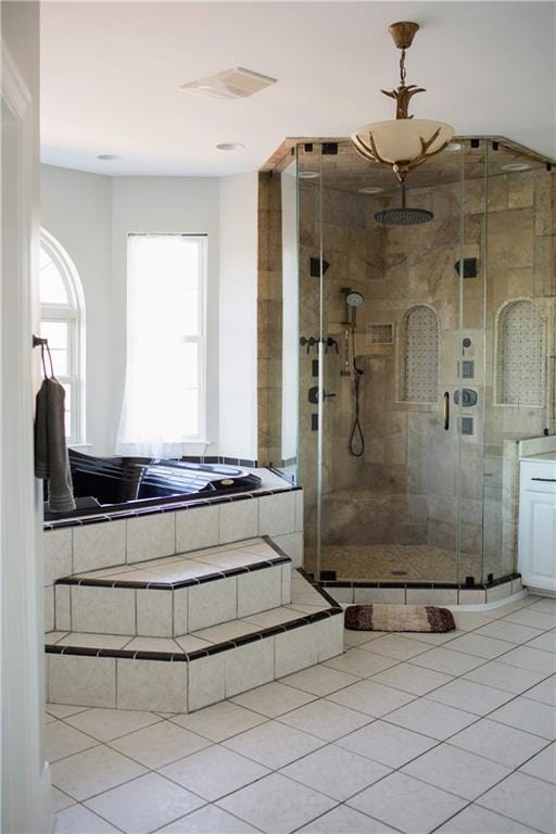 bathroom with tile patterned floors and a shower with door