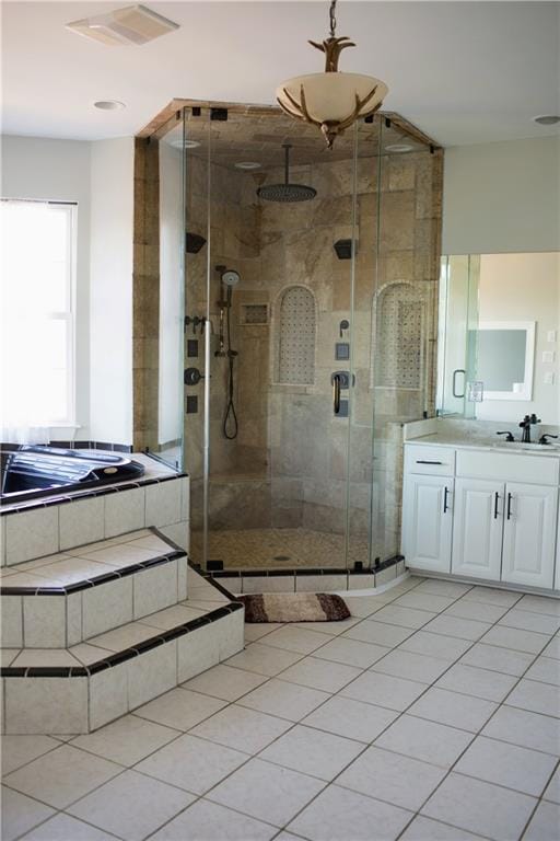 bathroom with tile patterned flooring, vanity, and an enclosed shower