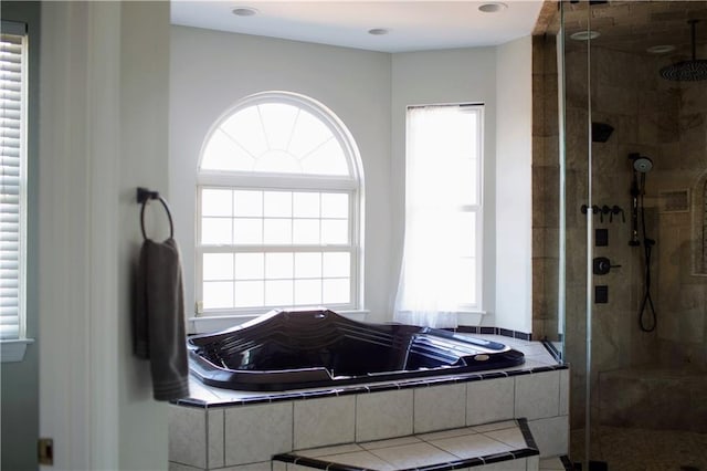 bathroom featuring plus walk in shower and a wealth of natural light