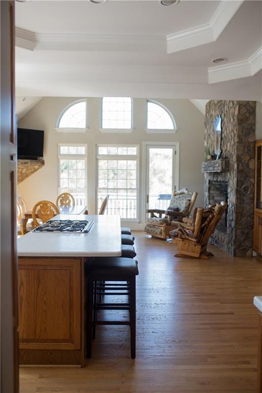 dining room with plenty of natural light, dark hardwood / wood-style floors, crown molding, and a fireplace