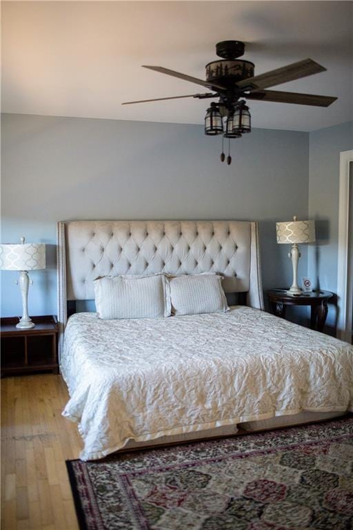 bedroom with ceiling fan and light hardwood / wood-style floors