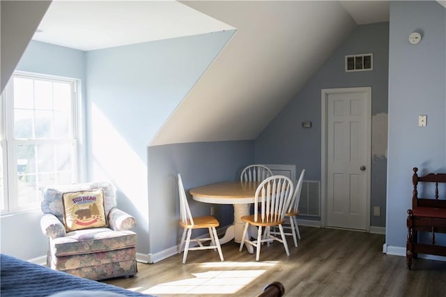 interior space with vaulted ceiling and hardwood / wood-style flooring