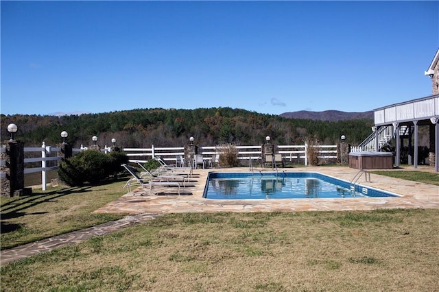 view of swimming pool featuring a yard and a patio