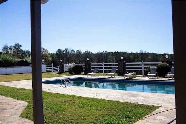 view of swimming pool featuring a yard and a patio