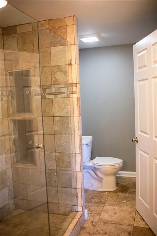 bathroom with toilet and an enclosed shower