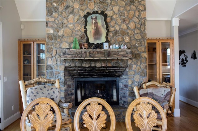 unfurnished living room featuring a fireplace, hardwood / wood-style flooring, crown molding, and lofted ceiling