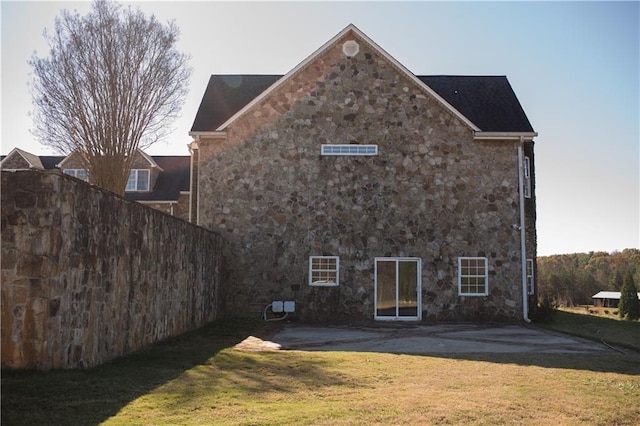 rear view of property featuring a yard and a patio