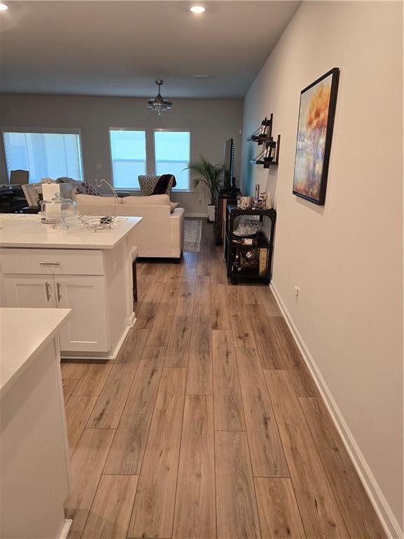 kitchen with white cabinets and light hardwood / wood-style floors