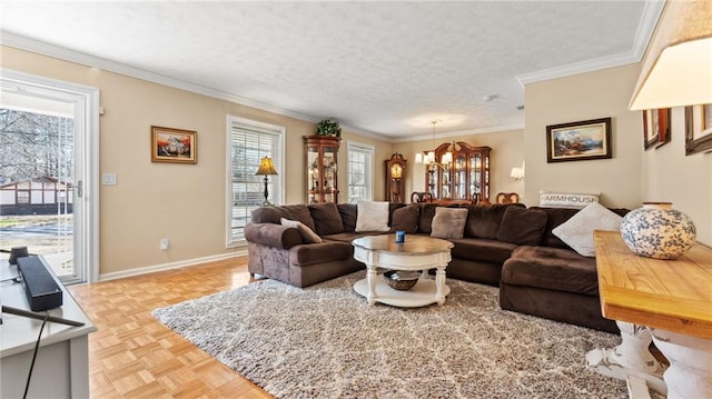 living area with crown molding, a notable chandelier, baseboards, and a textured ceiling