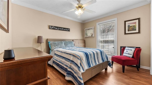 bedroom with a ceiling fan, wood finished floors, baseboards, and ornamental molding