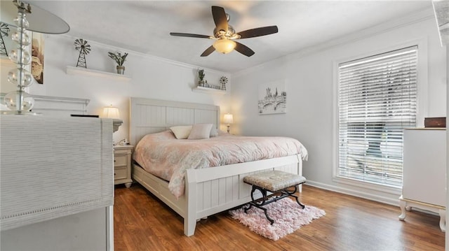 bedroom featuring wood finished floors, ornamental molding, and a ceiling fan