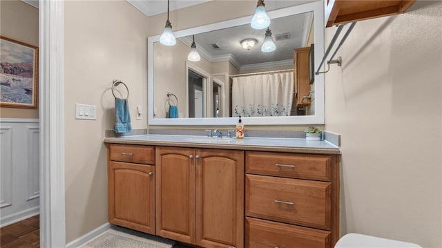 full bathroom with baseboards, toilet, ornamental molding, and vanity