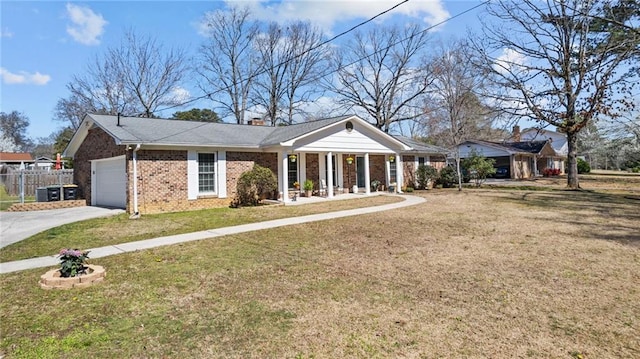 view of front of home featuring fence, concrete driveway, a front yard, a garage, and brick siding