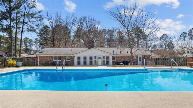 view of pool with a fenced in pool and fence