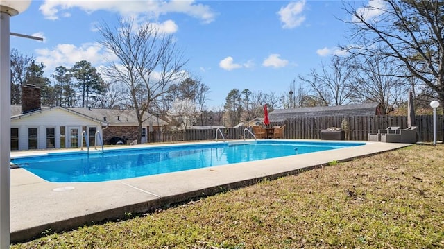 view of pool with a yard, a fenced in pool, a patio, and a fenced backyard