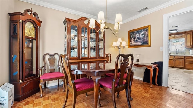 dining space featuring baseboards, visible vents, and ornamental molding