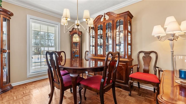 dining space featuring crown molding, baseboards, and a chandelier