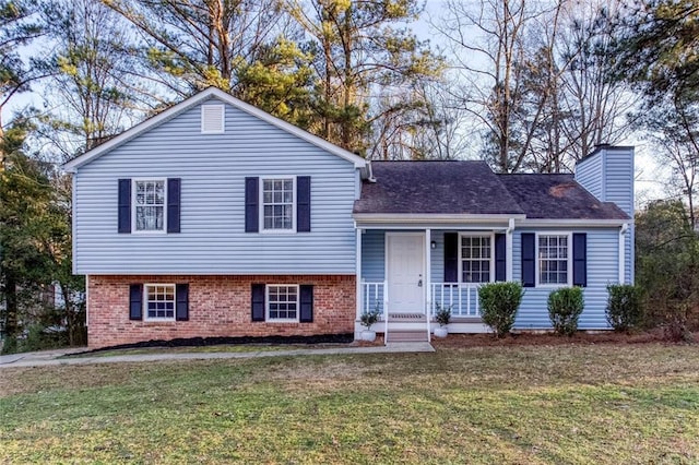 tri-level home featuring a porch and a front lawn