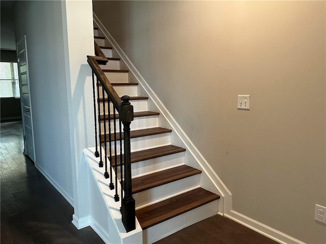 stairs featuring hardwood / wood-style floors