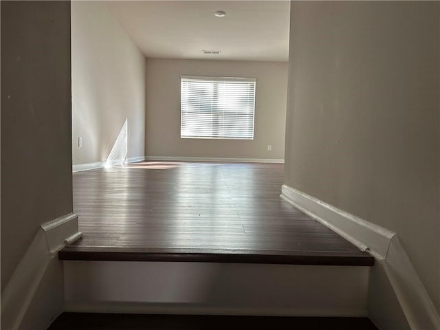 spare room with wood-type flooring