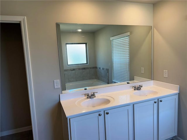 bathroom featuring vanity and a tub to relax in