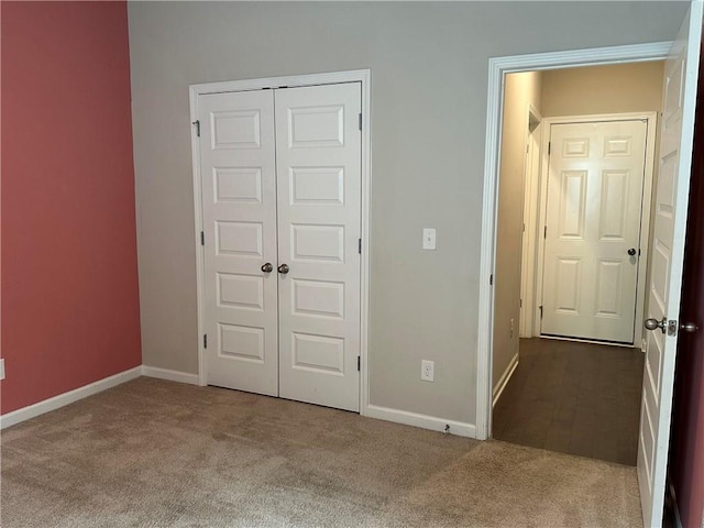 unfurnished bedroom with a closet and carpet