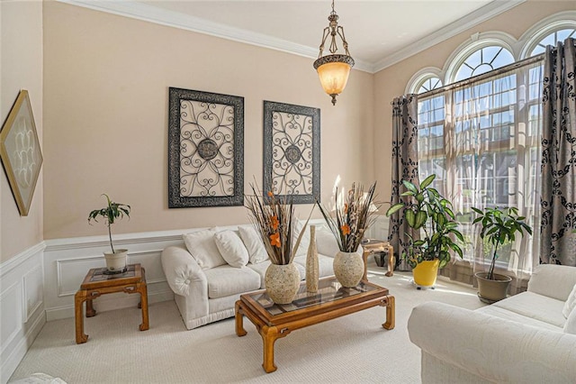 carpeted living room with wainscoting and crown molding