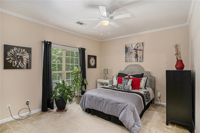 carpeted bedroom with crown molding, visible vents, baseboards, and a ceiling fan